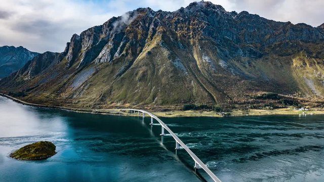 Gimsoystraumen bridge spanning above the narrow strait of Gimsoy, connecting islands Austv&aring;g&oslash;ya and Gims&oslash;ya. The tide is fast and powerful, carrying a huge mass of water through the narrow channel.