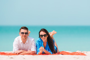 Fototapeta premium Young couple on white beach during summer vacation. Happy family enjoy their honeymoon