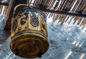 Single ornate brass pot hanging in a Souk street bazaar stall in Medina, Marrakesh, Morrocco