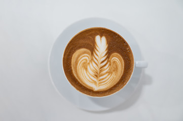 Close up of Latte art coffee cup in middle flat lay.