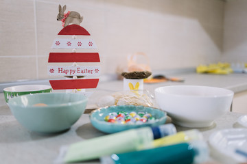 Preparation for Easter with eggs, bowls and paint
