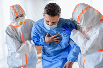 Doctors with infected patient in quarantine in hospital, coronavirus concept.