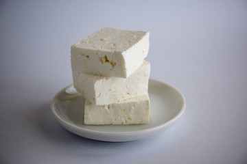 Sliced fresh white cheese from cow's milk on white background