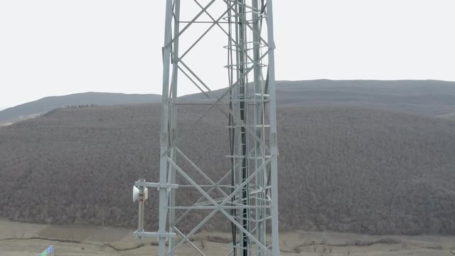 Tall Telecommunication Steel Mast With Ladder Built In Kaspi,Georgia Overlooking The Wide Field Under The Dramatic Sky - Aerial Shot