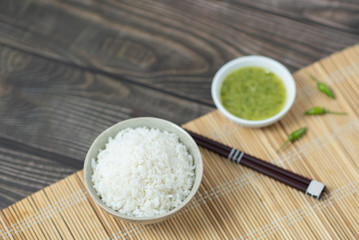  rice and chopsticks on wood table