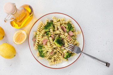 Apulian pasta fusilli with tuna fish, broccoli and lemon. Top view.