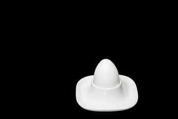 white fresh hen's egg in egg cup