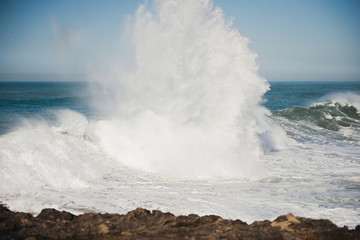 beautiful rugged coastline with waves crashing against the cliffs