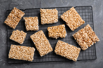 Delicious rice crispy treats on grey table, flat lay