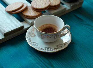 cup of coffee and cookies on table