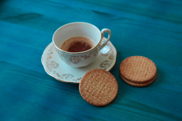 cup of coffee and cookies on wooden table