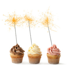 Birthday cupcakes with sparklers on white background