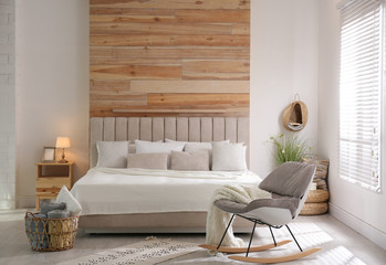Stylish room interior with big comfortable bed © New Africa