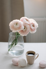 Coffee cup, flowers and marshmallows. Cozy home decor. Concept of holiday, birthday. Feminine blog. Spring wallpaper.