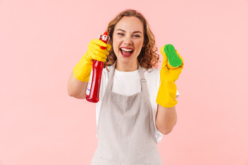 Woman housewife holding sponge an cleanser.