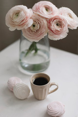 Spring still life. Coffee cup, flowers and marshmallows. Cozy home decor. Concept of holiday, birthday. Feminine flat lay