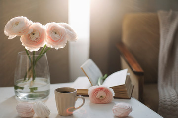 Spring home interior decor. Coffee cup, flowers, book. Concept of holiday, birthday. Blog, website or social media concept 
