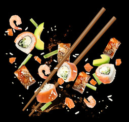 Different sushi rolls and ingredients on black background © New Africa
