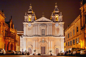 Fototapeta na wymiar Illuminated Metropolitan Cathedral of Saint Paul, commonly known as St Paul's Cathedral or the Mdina Cathedral. Night view on Roman Catholic cathedral in Mdina, Malta.