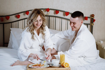 Romantic couple in bed, Valentine's day, just married.