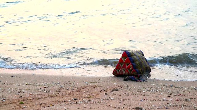 Triangle pillows were thrown into sea and struck on beach it a waste and environmental problem