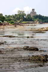 Lots of dirt and litter at the sandy beach in Conakry, Guinea, West Africa