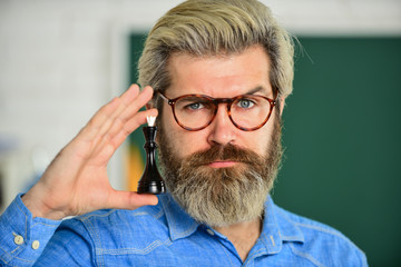 Fototapeta premium queen chess piece. logic development. leisure school time. Chess club for students. Logic game for brain development. Chess in Classroom. game strategy analysis. checkmate. intelligent hobby