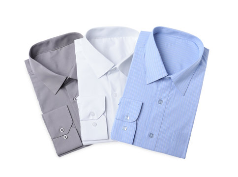 Stylish shirts isolated on white, top view. Dry-cleaning service