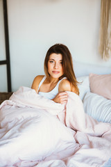 Young woman relax and smiling softly in bed.
