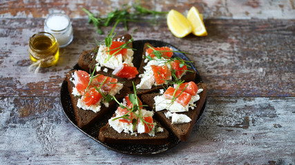 Toasts with salmon and white cheese on a plate. Keto diet. Keto toasts.