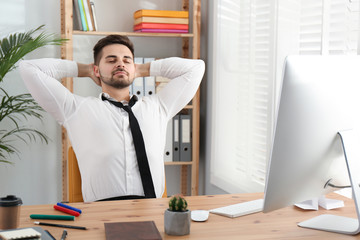 Lazy employee resting at table in office