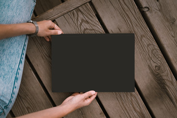 Girl holding black blank folder 