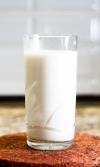 Glass of milk on a wooden stand
