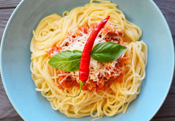 Delicious  spaghetti pasta dish served on a blue plate