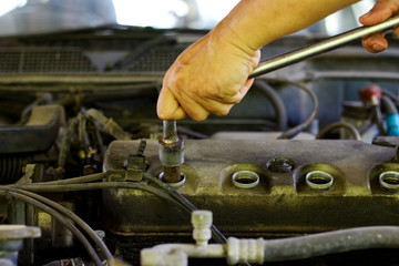 Hand use Wheel wrench with sparkplug wrench to Remove the spark plug for Repair Valve cover oil...