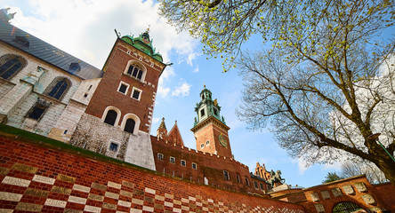 View on the walls of Wawel royal castle with Basilica of saint Stanislaus and Wenceslaus during the sunny morning in Krakow