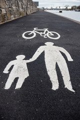 a white painted sign on a cycle lane for pedestrians and cyclists