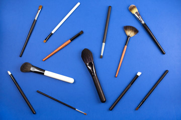 A lot of different brushes on a trendy blue background.