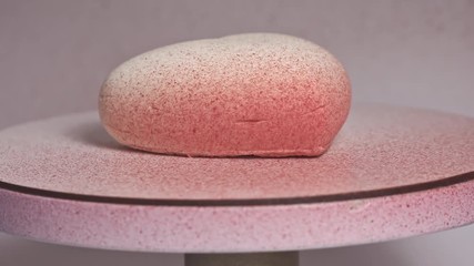 Close-up of confectioner decorates the cake with velour using the spray gun. Modern French mousse pastry dessert with chocolate velour. Heart shape