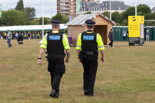 British Police Officers On Duty In Uniform