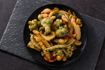 Japanese vegetable tempura on black background. Top view