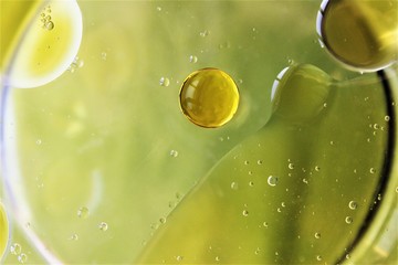 Abstract olive oil drop on water . photo 