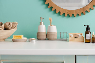 Beauty and hygiene products near bowl with towels in bathroom, zero waste concept