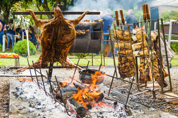 Meat and vegetable exhibition on a barbecue known as Parrilla. Typical barbecue from the south of Latin America. - 329384438