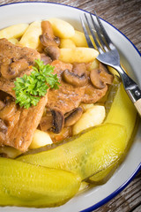 Braised pork loin with mushrooms.