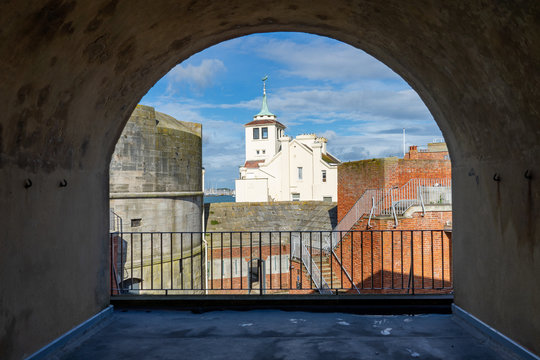 The round tower and old harbour masters house in Old Portsmouth, Portsmouth UK framed by an archway