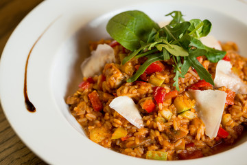 Risotto with chicken meat, zucchini and mushrooms in cream sauce