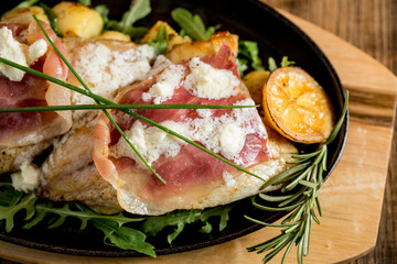 Sea bream stuffed with cream cheese and smoked ham with young potatoes and leek