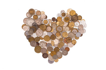 heart shape made of coins on a white isolated background. many different countries