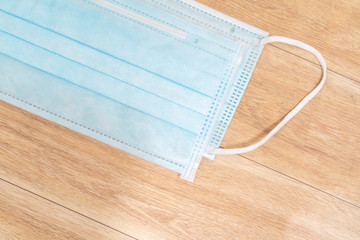 Surgical mask with rubber ear straps. Typical 3-ply surgical mask to cover the mouth and nose. Procedure mask from bacteria. Protection concept.